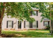 Charming two-story home featuring a well-manicured lawn and black shutters and front door at 1699 Riverdale Dr, Rock Hill, SC 29732