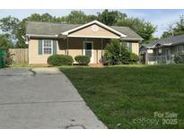 Charming home with a spacious front yard, a concrete driveway, and a cozy front porch at 1714 Maribel Ave, Charlotte, NC 28216