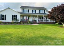 Charming two-story home featuring a welcoming front porch and a large, beautifully maintained lawn at 212 Countryside Rd, Kings Mountain, NC 28086