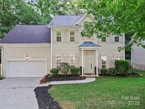 Charming two-story home featuring a well-manicured lawn and a classic facade with neutral siding and shutters at 216 Devon Forest Dr, Mooresville, NC 28115