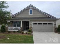 Charming single-Gathering home featuring a well-manicured lawn and a two-car garage at 567 Lincoln Quarters Ln, Tega Cay, SC 29708