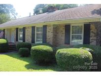 Charming brick home with manicured landscaping, offering curb appeal and classic design at 7017 Knightswood Dr, Charlotte, NC 28226