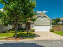 Charming home features a well-manicured front yard and a two-car garage, creating a welcoming curb appeal at 8036 Crater Lake Dr, Fort Mill, SC 29707