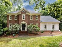 Charming brick home with a manicured lawn and beautiful landscaping at 9415 Braemar Ter, Charlotte, NC 28210