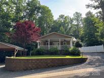 Charming single-story home with a welcoming front porch and meticulously landscaped front yard at 110 Indian Harbor Cir, Mount Gilead, NC 27306