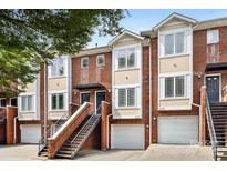Brick townhome exterior with stairs leading to the front door and attached garages at 1125 Kurt Ct, Charlotte, NC 28209