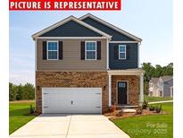 Charming two-story home with a brick facade, attached two car garage and well-maintained lawn at 12020 Zazu Way, Charlotte, NC 28215