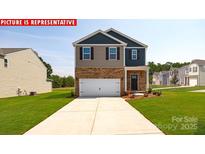 Two-story home featuring a two-car garage, brick accents, and a well-manicured lawn at 12020 Zazu Way, Charlotte, NC 28215