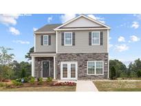 Charming two-story home with stone accents, gray siding, and a well-manicured front yard at 12020 Zazu Way, Charlotte, NC 28215