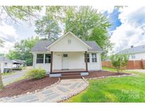 Charming home with a covered front porch and landscaped front yard, creating an inviting curb appeal at 1208 Martin Luther King Ave, Kannapolis, NC 28083