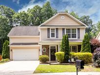 Charming two-story home with a manicured lawn and a two-car garage provides comfortable living at 12928 Windy Lea Ln, Huntersville, NC 28078