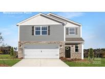Charming two-story home with stone accents, a white garage door, and well-maintained landscaping at 219 Parker Claire Ln, Kings Mountain, NC 28086