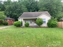 Charming single-story home featuring a cozy front porch and lush, verdant landscaping at 2722 Eastway Dr, Charlotte, NC 28205