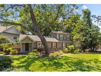 Charming two-story home featuring a covered front porch, mature trees, and well-maintained landscaping at 2800 Georgia Ave, Charlotte, NC 28205