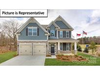 Charming two-story home featuring stone accents, a welcoming front porch, and a well-manicured lawn at 3122 Spring Iris Dr, Denver, NC 28037