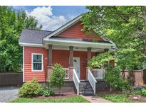 Charming home featuring a brick and wooden porch, complemented by lush landscaping and a freshly painted exterior at 3519 Card St, Charlotte, NC 28205