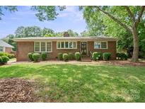 Charming brick home with a well-manicured lawn and lush landscaping in a desirable neighborhood at 3612 Trent St, Charlotte, NC 28209