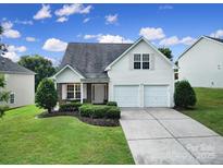 Charming two-story home with a well-manicured lawn, a two-car garage, and traditional architectural details at 3908 Parkers Ferry Rd, Fort Mill, SC 29715