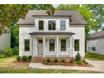 Charming two-story home with white siding, black trim, and a welcoming front porch at 513 Sacco St, Belmont, NC 28012