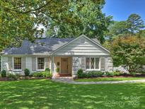 Charming white brick home featuring manicured landscaping and shuttered windows at 5436 Topping Pl, Charlotte, NC 28209