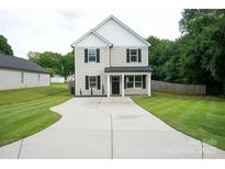 Charming two-story home featuring a spacious concrete driveway and manicured lawn at 103 Springway Dr, Kannapolis, NC 28081