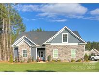 Charming single-story home with stone and gray siding, complemented by a well-maintained lawn at 1030 Stonegate Dr, Salisbury, NC 28147
