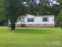 Exterior of home featuring brick base and green shutters at 111 Crystal Creek Dr, China Grove, NC 28023