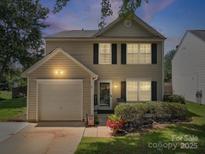 Charming two-story home with neutral siding, black shutters, an attached garage, and a well-maintained lawn at 1252 Winding Path Rd, Lake Wylie, SC 29710