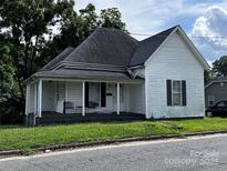 Charming single-Gathering home with a cozy front porch, traditional architecture, and well-maintained lawn at 128 Pine St, Shelby, NC 28152