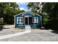 Charming blue home featuring new paint, white trim, covered entry and refreshed landscaping at 1406 Caldwell St, Gastonia, NC 28052
