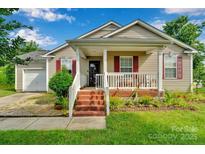 Charming single-story home featuring a welcoming front porch, brick steps, and well-maintained landscaping at 15248 Pangborn Pl, Charlotte, NC 28278