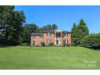 Charming brick home with a well-manicured lawn and classic architectural details at 1928 Providence Rd, Charlotte, NC 28211