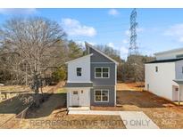 Charming two-story home featuring modern gray and white color scheme and contemporary architectural details at 213 Knot St, Shelby, NC 28150