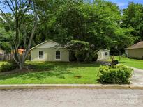 Charming single-story home with lush front lawn and mature trees creating a serene setting at 4333 Dunwoody Dr, Charlotte, NC 28215