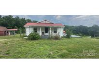Quaint single-story home with a red roof and covered front porch surrounded by a large yard at 439 Neisler Rd, Concord, NC 28025