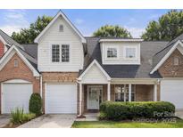 Charming townhome with a well-manicured lawn, brick accents, and attached garage at 4442 Coventry Row Ct, Charlotte, NC 28270