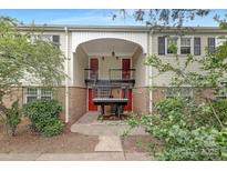 Townhome featuring a mix of brick and siding with red doors and trimmed with black shutters at 4601 Coronado Dr, Charlotte, NC 28212