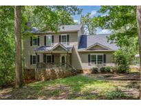 Charming two-story home with stone accents, covered front porch, and mature trees at 500 Mount Pleasant N Rd, Mount Pleasant, NC 28124