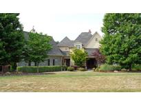 Charming two-story home with a well manicured lawn, stone accents, and mature trees at 5112 Mill Race Ln, Lancaster, SC 29720