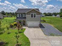 Charming two-story home featuring a two-car garage and a well-manicured front yard at 556 Big Lick Rd, Stanfield, NC 28163