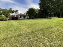 Beautiful home with an expansive green lawn and mature trees, offering a serene and inviting setting at 621 N Craige St # 25 & 27, Salisbury, NC 28144