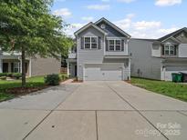 Charming two-story home with a two car garage and concrete driveway at 6803 Ware Rd, Charlotte, NC 28212