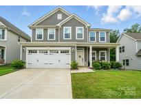 Charming two-story home with a two-car garage, landscaped yard, and inviting front porch at 812 Dogwood Creek Ln, Indian Trail, NC 28079
