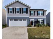 Charming two-story home with a two car garage, black shutters, and a welcoming front porch at 1047 Campbell Chase Sw Ln, Concord, NC 28025