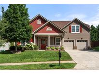 Charming two-story home with a welcoming front porch and well-manicured lawn, inviting curb appeal at 1152 Mckee Farm Ln, Belmont, NC 28012