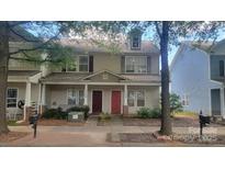 Charming two-story townhome with inviting front porch and well-maintained landscaping at 12450 Stone Garden Dr, Huntersville, NC 28078
