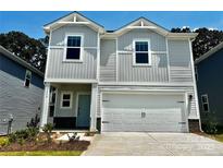 Charming two-story home with a white garage door, light blue front door, and manicured lawn at 1442 31St Ne St, Conover, NC 28613