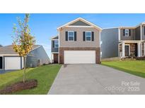 Charming two-story home featuring a brick and siding exterior, attached garage, and well-maintained lawn at 1450 Mammoth Rd, Hickory, NC 28602