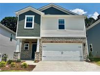 Charming two-story home featuring stone accents, a two-car garage, and a mix of traditional and modern design elements at 1458 31St Ne St, Conover, NC 28613