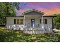 Charming white brick home with a welcoming front porch and landscaped front yard at 161 Ranson Rd, Lancaster, SC 29720